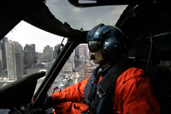 Coast Guard Lt. Rob Donnell flys over Boston, Friday, March 25, 2005. To protect the nation's coastline from terrorist attacks, the U.S. Department of Homeland Security is dramatically expanding the Coast Guard's firepower, training and surveillance equip