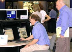 John Waldstein, president and CEO of International Electronics, Inc. (IEI) provides a demonstration to an attendee at the the 2005 Systems Integration Expo in Orlando.