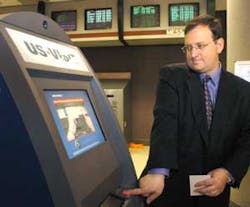 Joe Newcomer demonstrates the new departure procedure for foreign visitors, using the US-VISIT biometric exit pilot, during a news conference, at Hartsfield-Jackson Atlanta International Airport in Atlanta, Thursday, March 31, 2005. Visitors must record t