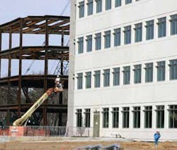 Contractors work on a new office building being constructed in the National Business Park in Columbia, Md., Wednesday, March 30, 2005. Business is booming for buildings designed to keep secrets. Structures with 8-inch-thick concrete walls, elaborate alarm