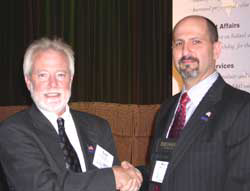 NBFAA President Scot Colby (left) presents the 2005 President's Award to Executive Director Merlin Guilbeau. Guilbeau is the first NBFAA staff person to receive the award.