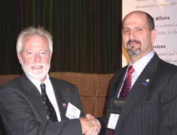NBFAA President Scot Colby (left) presents the 2005 President's Award to Executive Director Merlin Guilbeau. Guilbeau is the first NBFAA staff person to receive the award. NBFAA President Scot Colby (left) presents the 2005 President's Award to Executive Director Merlin Guilbeau. Guilbeau is the first NBFAA staff person to receive the award.