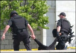 Captiol Police remove an unidentified man who stood in front of the U. S. Capitol Monday, April 11, 2005, with two suitcases. Captiol Police remove an unidentified man who stood in front of the U. S. Capitol Monday, April 11, 2005, with two suitcases.