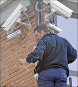 A worker installs surveillance cameras at a Spain courthouse in Madrid where al-Qaida suspects go on trial Friday. A worker installs surveillance cameras at a Spain courthouse in Madrid where al-Qaida suspects go on trial Friday.
