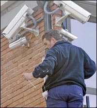 A worker installs surveillance cameras at a Spain courthouse in Madrid where al-Qaida suspects go on trial Friday.