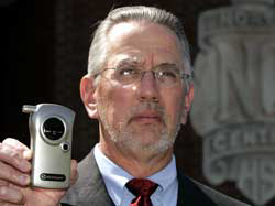 North Central High School Principal C.E. Quandt poses with the school's breathalyzer Friday, April 14, 2005, at the Indianapolis school. The school has been doing student alcohol testing at events for 10 years and Quandt has never had a student test posit