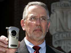 North Central High School Principal C.E. Quandt poses with the school&apos;s breathalyzer Friday, April 14, 2005, at the Indianapolis school. The school has been doing student alcohol testing at events for 10 years and Quandt has never had a student test posit