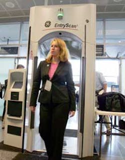 Ann Davis, public affairs manager of Transportation Security Administration, goes through an Explosives Detection Trace Portal machine during a demonstration at the Logan International Airport in Boston, Monday, April 25, 2005. The TSA announced Monday it