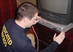 A Dedicated Micros employee installs the company's Digital Sprite 2 multiplexing recording system to manage video cameras installed as part of The Discovery Channel show 'It Takes a Thief'. A Dedicated Micros employee installs the company's Digital Sprite 2 multiplexing recording system to manage video cameras installed as part of The Discovery Channel show 'It Takes a Thief'.