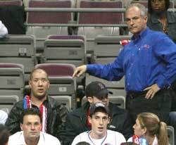 A security guard stands next to Michael A. Roberts, as he points to Dennis Pauley, seated at top left, during the final minutes of the Detroit Pistons game against the Philadelphia 76ers in game two of the Eastern Conference quarterfinals at The Palace in
