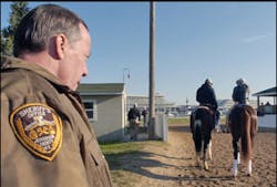 Jefferson County Deputy Sheriff Bill Luckhardt keeps a close watch on Kentucky Derby entrant Buzzards Bay, right, with Amy Mullins up, as trainer Jeff Mullins gets set to lead them on to the track Thursday, May 5, 2005, at Churchill Downs in Louisville Jefferson County Deputy Sheriff Bill Luckhardt keeps a close watch on Kentucky Derby entrant Buzzards Bay, right, with Amy Mullins up, as trainer Jeff Mullins gets set to lead them on to the track Thursday, May 5, 2005, at Churchill Downs in Louisville
