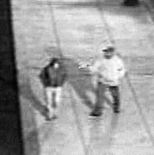 In this handout photo released by the Philadelphia Police Department, a Tuesday, May 17, 2005, video still shows murder victim Patricia McDermott, left, and her unidentified killer moments before McDermott was shot on a downtown Philadelphia street. McDer