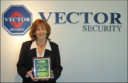 Pat Killian, false alarm reduction program manager for Vector Security, shows off the award she recently received fromt eh False Alarm Reduction Association (FARA).