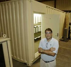 Charles Merrill, chairman of Kontek Industries Inc., poses near a modified shipping container in New Madrid, Mo. The company which once questioned its ability to survive has found a second life as a homeland security business.
