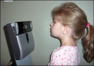 A child uses the Panasonic BM-ET330 iris reader, demonstrating the process it takes to record a child&apos;s iris into a national database that will be used to help identify missing children.