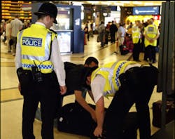 British Transport Police search the luggage of a passenger at King's Cross station, in London, Monday, July 11, 2005. Security has been stepped up in the wake of last Thursday's attacks on London's transport system. British Transport Police search the luggage of a passenger at King's Cross station, in London, Monday, July 11, 2005. Security has been stepped up in the wake of last Thursday's attacks on London's transport system.