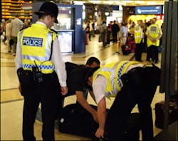 British Transport Police search the luggage of a passenger at King&apos;s Cross station, in London, Monday, July 11, 2005. Security has been stepped up in the wake of last Thursday&apos;s attacks on London&apos;s transport system.