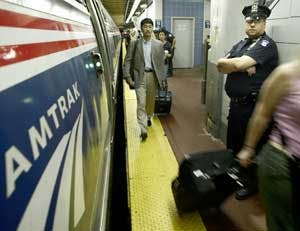 A New York City police officer keeps an eye out on an Amtrak platform inside Penn Station during the morning rush hour, Monday, July 18, 2005, in New York. Police officers boarded Washington, D.C. bound trains to teach passengers how to recognize suicide
