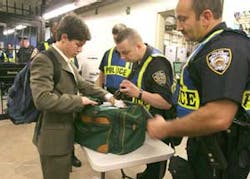 Jack Schinasi, of Yonkers, New York, left, has his bag inspected by members of the New York Police Department upon entering the Woodlawn subway station in the Bronx borough of New York, Friday July 22, 2005. Random inspections were made at the station whe Jack Schinasi, of Yonkers, New York, left, has his bag inspected by members of the New York Police Department upon entering the Woodlawn subway station in the Bronx borough of New York, Friday July 22, 2005. Random inspections were made at the station whe