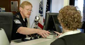 TAGS United States Customs and Border Patrol officer Jeff Hutter, left, tests the new radio frequency identification tag system during a demonstration for reporters at the U.S. Canadian border crossing in Alexandria Bay, N.Y., Monday, Aug. 8, 2005.