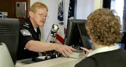 TAGS United States Customs and Border Patrol officer Jeff Hutter, left, tests the new radio frequency identification tag system during a demonstration for reporters at the U.S. Canadian border crossing in Alexandria Bay, N.Y., Monday, Aug. 8, 2005. TAGS United States Customs and Border Patrol officer Jeff Hutter, left, tests the new radio frequency identification tag system during a demonstration for reporters at the U.S. Canadian border crossing in Alexandria Bay, N.Y., Monday, Aug. 8, 2005.