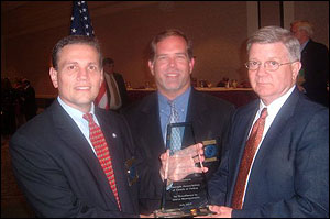 Chief Dekmar (left) and Chief Cotton (center) accept the award from SIAC law enforcement liaison Glen Mowrey.