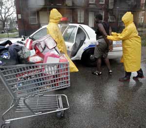 A person is arrested after allegedly looting a grocery store during Hurricane Katrina in New Orleans, Monday, Aug. 29, 2005.