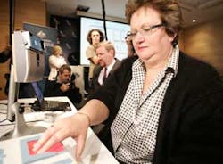 Senator Amanda Vanstone, right, places her hand on a finger print scanner during a biometric system demonstration at Sydney International Airport in Australia, Thursday, Sept. 29, 2005. Senator Vanstone announced that in a bid to enhance border security,