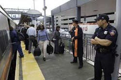Police monitor the Stamford, Conn., train tracks that service Amtrak and Metro-North, Friday Oct. 7, 2005. Gov. M. Jodi Rell on Thursday night ordered increased security on Metro-North trains because of what New York City officials called a credible threa