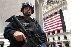 New York City police officers from Emergency Service Unit stand guard outside the New York Stock Exchange on Friday, Oct. 7, 2005. Threats to the city&apos;s mass transit system remained uncorroborated by evidence.