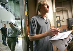University of Wisconsin engineering student Ben Schmitt checks photo identifications as he allows members of the media into the research reactor room, left, at the university in Madison, Wis., Thursday, Oct. 13, 2005. UW officials explained security and s University of Wisconsin engineering student Ben Schmitt checks photo identifications as he allows members of the media into the research reactor room, left, at the university in Madison, Wis., Thursday, Oct. 13, 2005. UW officials explained security and s