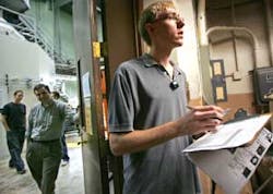 University of Wisconsin engineering student Ben Schmitt checks photo identifications as he allows members of the media into the research reactor room, left, at the university in Madison, Wis., Thursday, Oct. 13, 2005. UW officials explained security and s