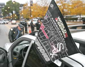 Chicago police officers inspect a spectator's vehicle before it enters the closed off area near U.S. Cellular Field prior to Game 2 of the World Series.