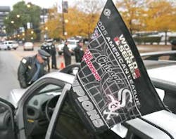 Chicago police officers inspect a spectator's vehicle before it enters the closed off area near U.S. Cellular Field prior to Game 2 of the World Series. Chicago police officers inspect a spectator's vehicle before it enters the closed off area near U.S. Cellular Field prior to Game 2 of the World Series.