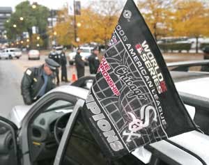 Chicago police officers inspect a spectator&apos;s vehicle before it enters the closed off area near U.S. Cellular Field prior to Game 2 of the World Series.