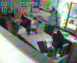 According to the FBI, this image from surveillance video, released Tuesday, Oct. 25, 2005, shows one of two suspects holding a gun during the robbery of the WestStar Bank in Vail, Colo., March 21, 2005. According to the FBI, this image from surveillance video, released Tuesday, Oct. 25, 2005, shows one of two suspects holding a gun during the robbery of the WestStar Bank in Vail, Colo., March 21, 2005.