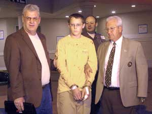Campbell County Sheriff's Department Captain Don Farmer, left, and Campbell County Sheriff Ron McClellan, right, escort the suspect in the Campbell County High School shootings from a hospital in LaFollette, Tenn., after the suspect was treated and releas