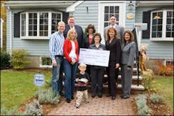 Front Row, from left to right: Millionth Brink&apos;s customers: The Stolarz family (Mr. and Mrs. E. Stolarz and son); American Cancer Society representative Jean Martinho, Vice President for Planned Giving; Carole Vanyo, Brink&apos;s Sr. Vice President, Customer