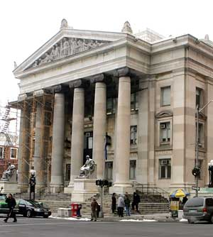 People stand on the steps of Superior Court in New Haven, Conn., Monday, Dec. 5, during a routine day. On the previous Friday, Dec. 2, this court was evacuated, along with several other courthouses throughout the state after a bomb threat. Homeland Securi