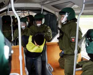 German police arrest a mock hooligan, played by a colleague, during a practice session for the Confederations Cup and the World Cup 2006 in Hanover, northern Germany,in this file phtot from May 19, 2005. Police don't have enough manpower to provide securi
