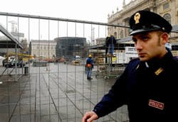A police officer passes next to the Castello Square that will host the medal ceremonies of the XX Winter Olympics Games, in downtown Turin, Italy. The equivalent of $107M in U.S. funds has been spent preparing the security operations of the Feb. 10-26 Win