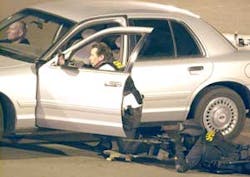 Police officers draw guns and surround the perimeter of the Bank of America in Exeter, Calif., Wednesday, Jan. 25, 2006, during a standoff with an armed suspect holding multiple hostages in Exeter, Calif. The standoff ended peacefully after the last hosta Police officers draw guns and surround the perimeter of the Bank of America in Exeter, Calif., Wednesday, Jan. 25, 2006, during a standoff with an armed suspect holding multiple hostages in Exeter, Calif. The standoff ended peacefully after the last hosta