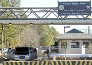 Guards stationed at an entrance to the Pine Bluff Arsenal inspect exiting vehicles Wednesday, Jan. 25, 2006 in Pine Bluff, Ark., after three unauthorized people, according to officials. were spotted on the grounds earlier Wednesday. The Pine Bluff Arsenal