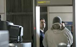 A U.S. Department of HomelandSecurity screener, center left, watches as a train passenger walks through a metal detection machine at the Exchange Place PATH train station in Jersey City, N.J. A U.S. Department of HomelandSecurity screener, center left, watches as a train passenger walks through a metal detection machine at the Exchange Place PATH train station in Jersey City, N.J.