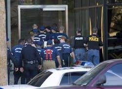 Police, and medical personnel from the fire department, enter a Phoenix high-rise Thursday, Feb. 23, 2006. A gunman held up to nine people hostage Thursday in an office in the building, a police spokesman said. Sgt. Andy Hill said everyone was inside a he Police, and medical personnel from the fire department, enter a Phoenix high-rise Thursday, Feb. 23, 2006. A gunman held up to nine people hostage Thursday in an office in the building, a police spokesman said. Sgt. Andy Hill said everyone was inside a he