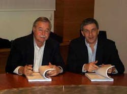 Tom Polson, President of ADI (left) and Jean-Francios Gazielly, CEO of Gardiner Groupe Euorpe (right), formalize the acquisition of Gardiner Groupe by Honeywell/ADI.