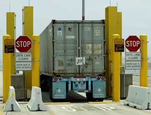 A truck passes through a radiation portal monitor Wednesday, July 20, 2005, at the Port of Los Angeles. A recent battle in the House rejected an amendment offered by Rep. Edward Markey, D-Mass., which would require within five years radiation screening fo