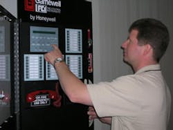 Paul Melcher, sales engineer for IQ Life Safety Systems of Holly, Mich., programs one of Gamewell-FCIÂ’s E3 Series fire alarm control panels. Paul Melcher, sales engineer for IQ Life Safety Systems of Holly, Mich., programs one of Gamewell-FCIÂ’s E3 Series fire alarm control panels.