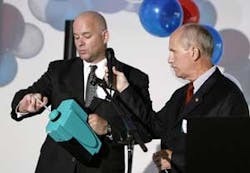 John Dowd, left, and Dennis Koehler, right, of Isonics Corporation demonstrate the company&apos;s new handheld IMS detection unit to an audience of law enforcement and homeland security on Wednesday, Aug. 2, 2006, at the PartnerTech manufacturing facility in D