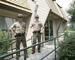 EAST THETFORD VT USA -- Vermont state troopers stand at the entrance to the Merchants Bank in East Thetford, Vt., Wednesday, Aug. 2, 2006. A two-hour hostage standoff involving an apparent bank robber and two bank employees ended peacefully Wednesday with